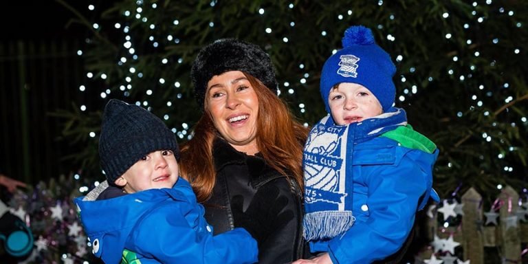 Woman holding 2 children