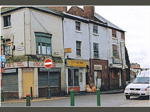 Back-to-back court housing, empty shops at the ground level